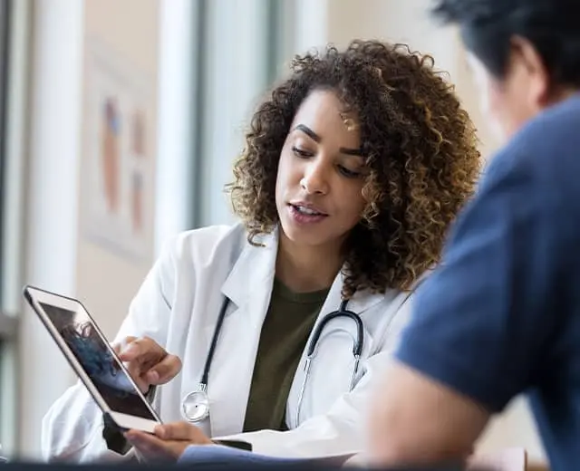 Healthcare professional using mobile technology to enhance clinical expertise and patient care